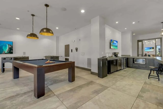 Pool table foosball tables kitchen lounge area at West 10 Apartments in Tallahassee Student Accommodation