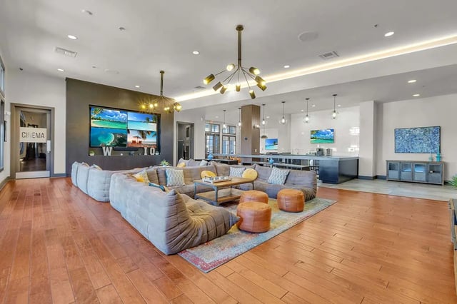Large sectional sofa with ottomans living area at West 10 Apartments in Tallahassee Student Accommodation