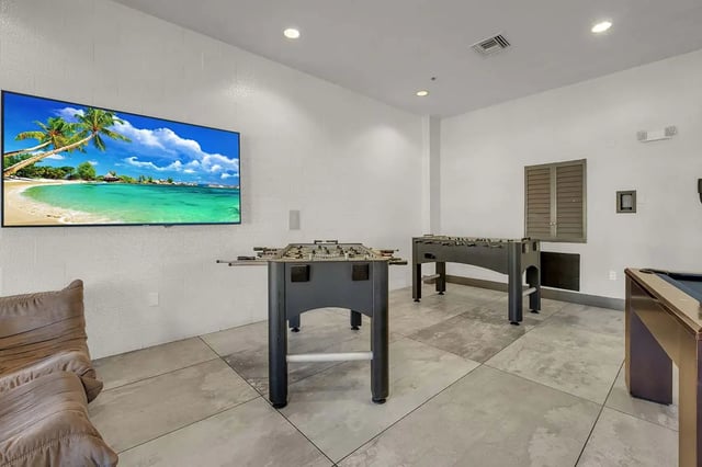 Foosball tables and large TV in lounge area at West 10 Apartments in Tallahassee Student Accommodation