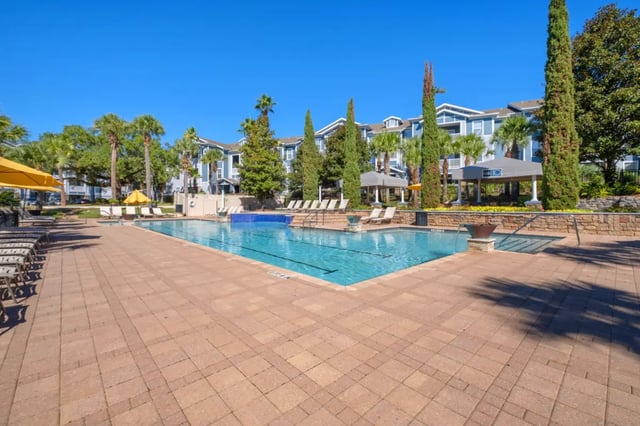 Resort style pool lounge chairs and cabanas exterior at West 10 Apartments in Tallahassee Student Accommodation