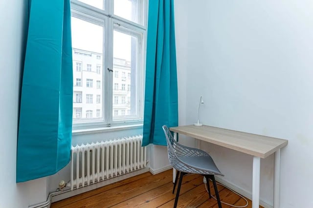 Desk chair lamp on wooden floor study area at Kaiser-Friedrich-Straße - Room 4 in Berlin Student Accommodation