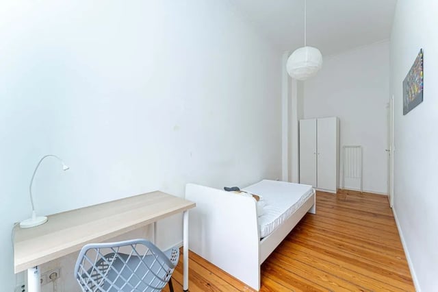 Bed desk chair lamp wardrobe bedroom at Kaiser-Friedrich-Straße - Room 4 in Berlin Student Accommodation