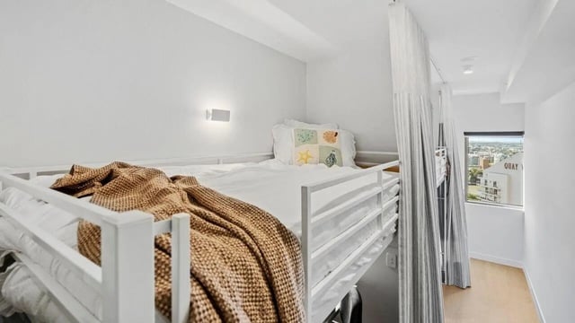 Bunk bed with white bedding and brown blanket bedroom at UniLodge Brisbane City in Brisbane Student Accommodation