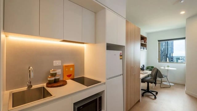 Kitchen area with study desk window and city view living room at UniLodge Brisbane City in Brisbane Student Accommodation