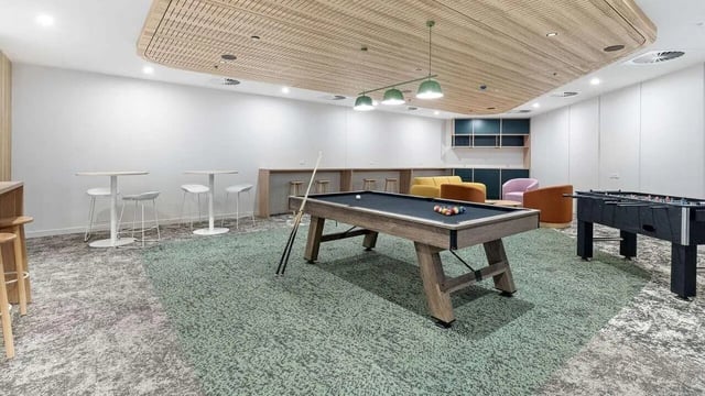 Billiard table foosball table lounge chairs common area at UniLodge Brisbane City in Brisbane Student Accommodation