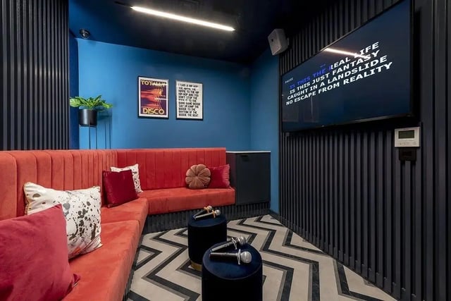 Red sofa microphones screen karaoke room at Silk Mill Edinburgh in Edinburgh Student Accommodation