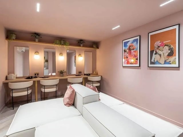 Mirrors lights chairs and a white sofa communal area at Bridle Works Glasgow in Glasgow Student Accommodation