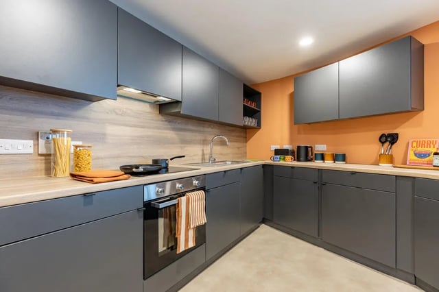 Modern grey cabinets wood countertop pasta and oven kitchen at Croft Court in Bristol Student Accommodation