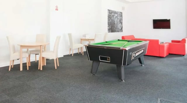 Pool table chairs and red sofas Common room at Brayford Quay in Lincoln Student Accommodation