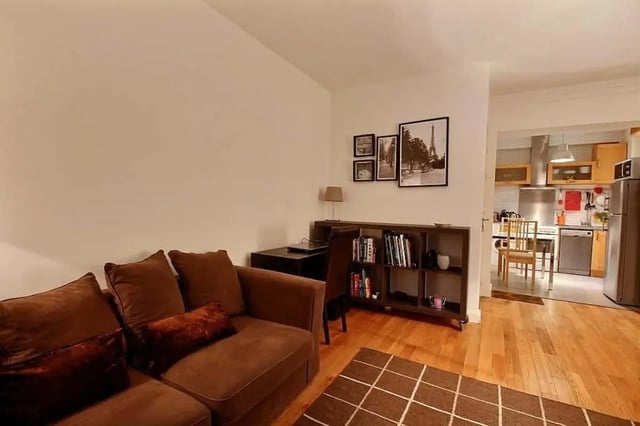Brown sectional couch bookcase and kitchen living room at Apartment in Rue Claude Terrasse, 75016 Paris, France in Paris Student Accommodation