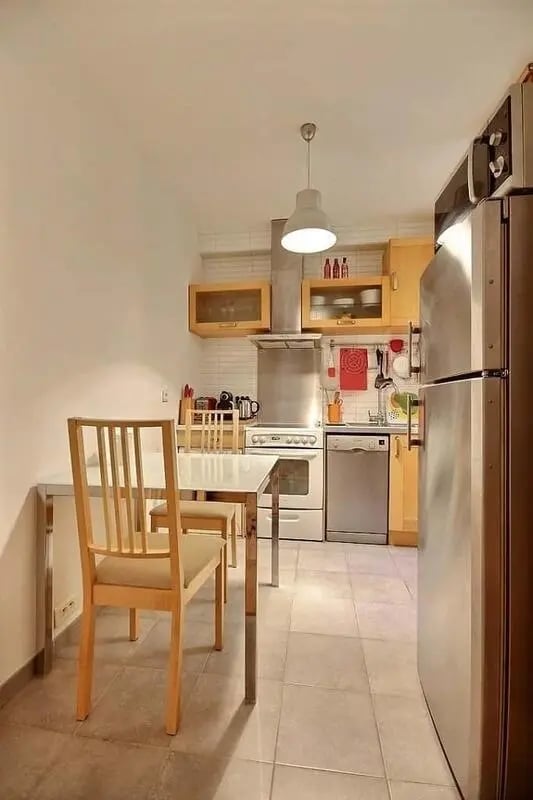 Table chairs oven refrigerator kitchen at Apartment in Rue Claude Terrasse, 75016 Paris, France in Paris Student Accommodation