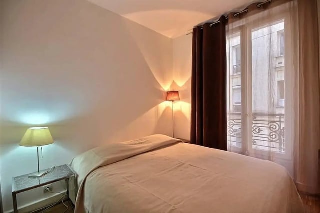 Bed bedside tables lamps and window bedroom at Apartment in Rue Claude Terrasse, 75016 Paris, France in Paris Student Accommodation