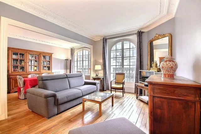 Gray sofa glass coffee table bookcase living room at Apartment in Rue Damrémont, 75018 Paris, France in Paris Student Accommodation