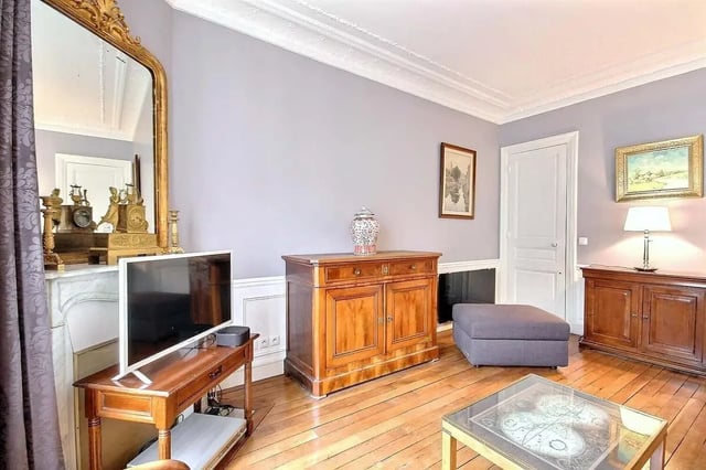Television antique cabinet ottoman and living room. at Apartment in Rue Damrémont, 75018 Paris, France in Paris Student Accommodation