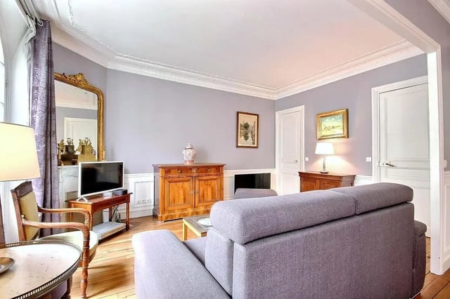 Grey sofa antique cabinet and television living room at Apartment in Rue Damrémont, 75018 Paris, France in Paris Student Accommodation