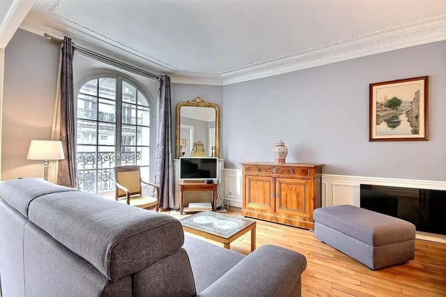 Sofa armchair cabinet TV mirror painting living room at Apartment in Rue Damrémont, 75018 Paris, France in Paris Student Accommodation