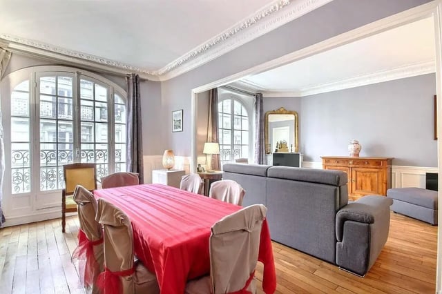 Dining table with red cloth grey couch living room at Apartment in Rue Damrémont, 75018 Paris, France in Paris Student Accommodation