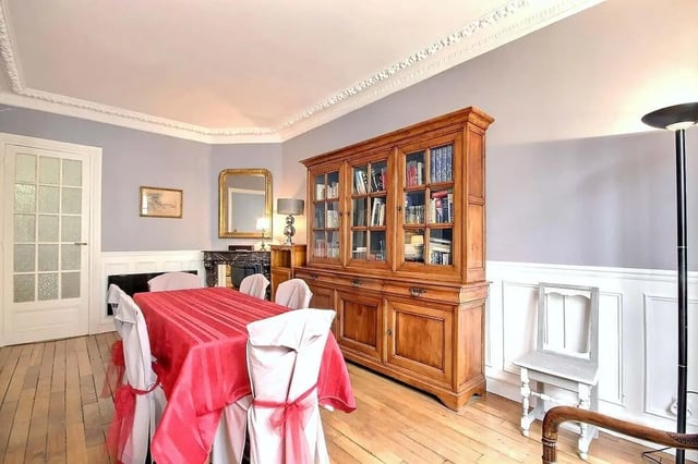 Dining table with red tablecloth chairs wooden cabinet living room at Apartment in Rue Damrémont, 75018 Paris, France in Paris Student Accommodation
