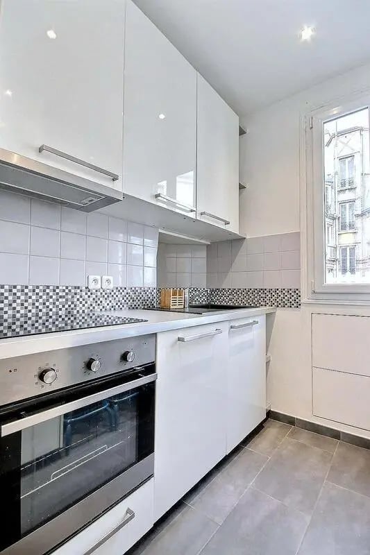White cabinets oven stovetop countertop kitchen at Apartment in Rue Damrémont, 75018 Paris, France in Paris Student Accommodation