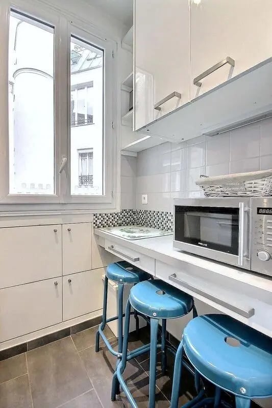 Countertop microwave blue stools cabinets kitchen at Apartment in Rue Damrémont, 75018 Paris, France in Paris Student Accommodation