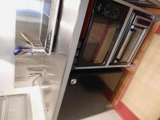 Stainless steel sink microwave oven and cutlery kitchen at Studio in Rue de Dantzig, 75015 Paris, France in Paris Student Accommodation