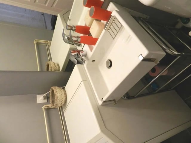 White sinks chrome faucets orange holders bathroom at Studio in Rue de Dantzig, 75015 Paris, France in Paris Student Accommodation