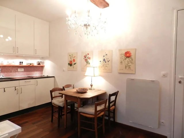 Dining area with table chairs and kitchen dining area at Studio in Rue Dauphine, 75006 Paris, France in Paris Student Accommodation