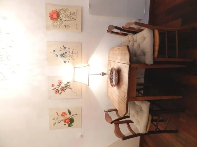 Floral prints wooden table chairs lamp dining area at Studio in Rue Dauphine, 75006 Paris, France in Paris Student Accommodation
