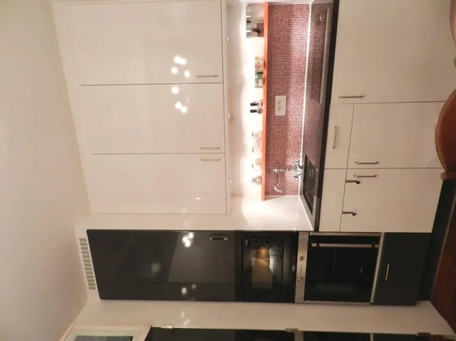 White cabinets sink oven microwave kitchen at Studio in Rue Dauphine, 75006 Paris, France in Paris Student Accommodation
