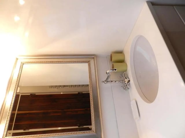 Mirror sink faucet and toilet rolls bathroom at Studio in Rue Dauphine, 75006 Paris, France in Paris Student Accommodation
