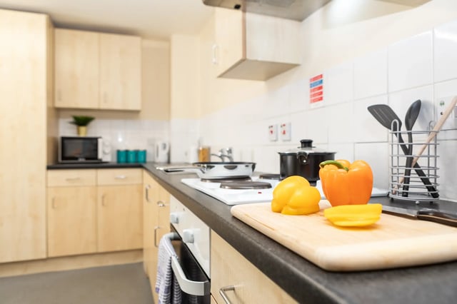 Peppers on cutting board and stovetop kitchen at Albert Court in Liverpool Student Accommodation