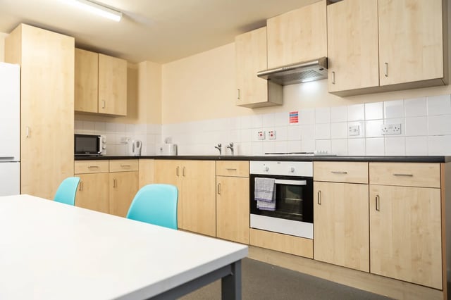 Kitchen with light wood cabinets oven and microwave kitchen at Albert Court in Liverpool Student Accommodation