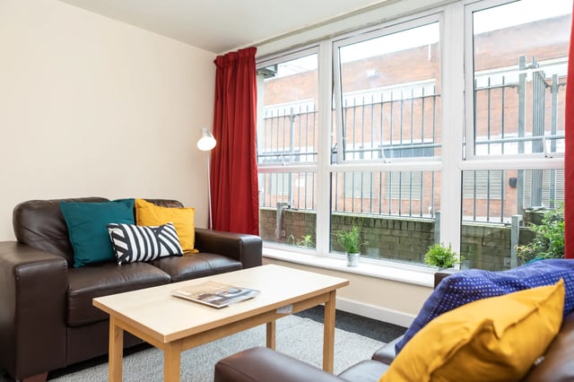Brown sofa with colorful pillows and coffee table Living room at Albert Court in Liverpool Student Accommodation
