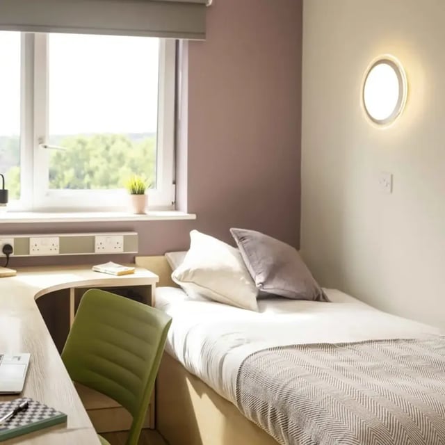 Bed desk and green chair student bedroom at Belgrave View in Birmingham Student Accommodation
