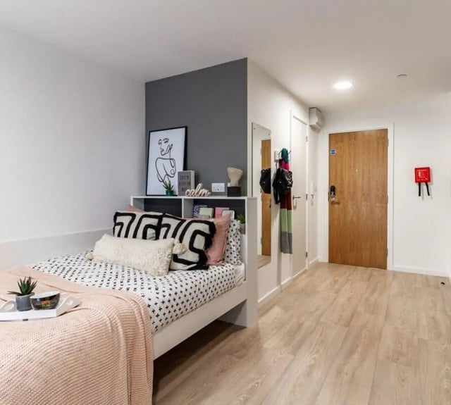 Bed with modern decor and entryway bedroom at Pavilion Court London in Wembley Student Accommodation
