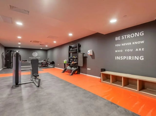 Gym equipment rowing machine weights bench living room at Pavilion Court London in Wembley Student Accommodation