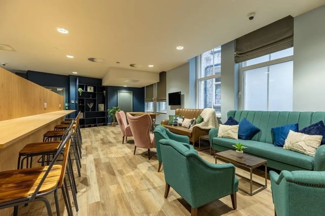 Seating and a long counter with stools common area at Chamberlain Place in Birmingham Student Accommodation