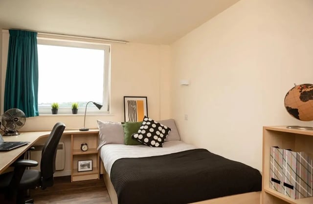 Desk bed pillows and globe bedroom at Burley Road in Leeds Student Accommodation