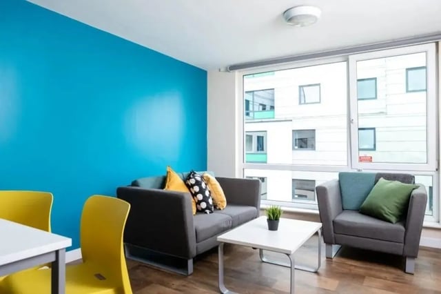 Two sofas coffee table yellow chairs living room at Burley Road in Leeds Student Accommodation