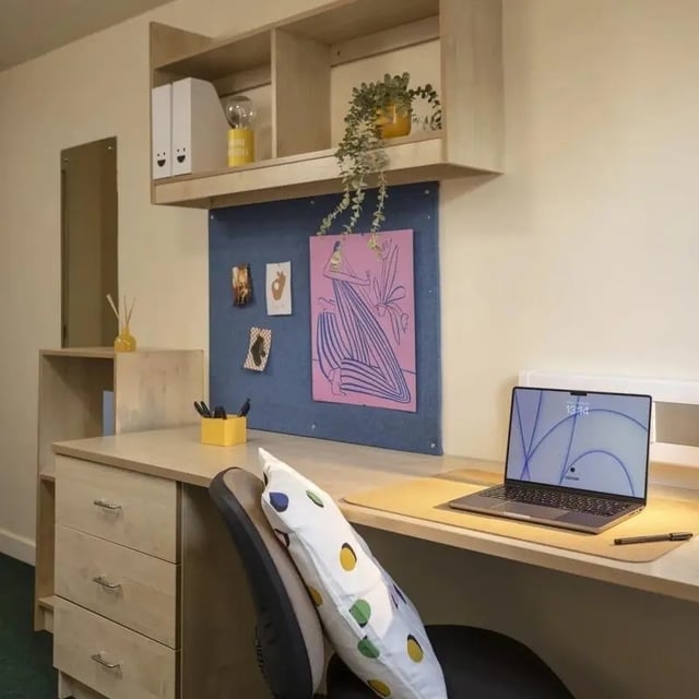 Desk drawers bulletin board laptop study area at Burley Road in Leeds Student Accommodation