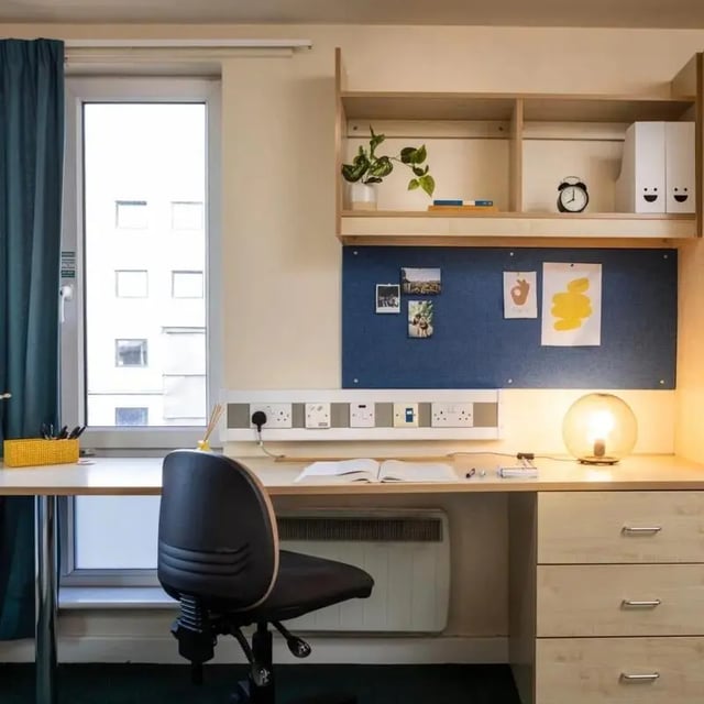 Desk chair with drawers plant and lamp study area at Burley Road in Leeds Student Accommodation