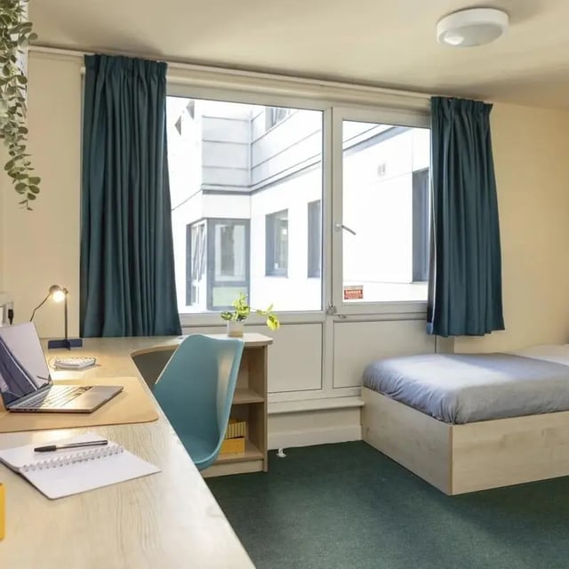 Desk bed laptop and chair student room at Burley Road in Leeds Student Accommodation
