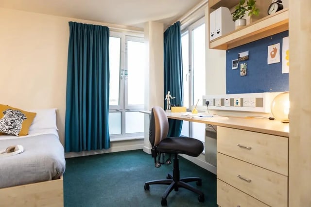 Bed desk chair pinboard and plant bedroom at Burley Road in Leeds Student Accommodation