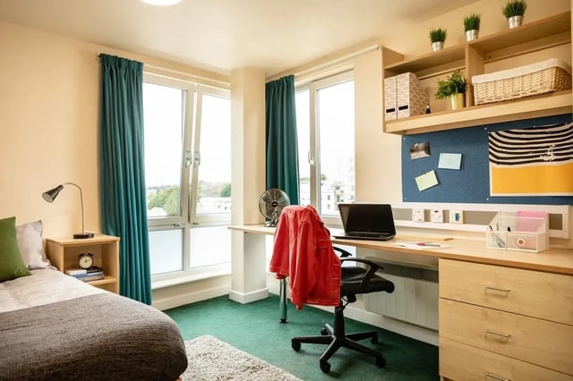 Bed desk chair fan and windows bedroom at Burley Road in Leeds Student Accommodation