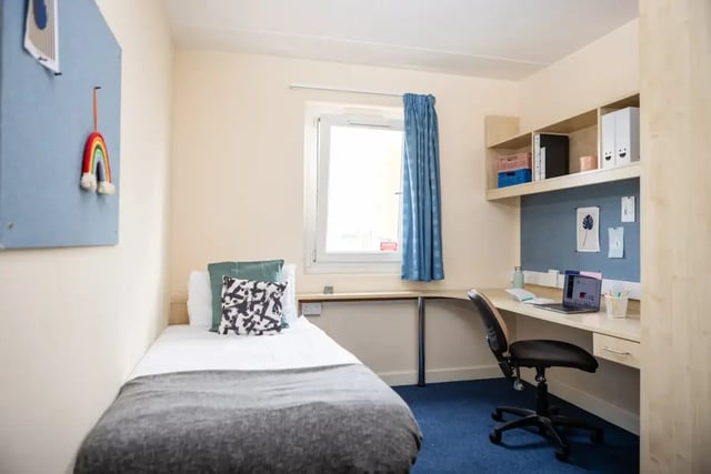 Bed desk chair window with blue curtains bedroom at Mcmillan student Village in Greenwich Student Accommodation