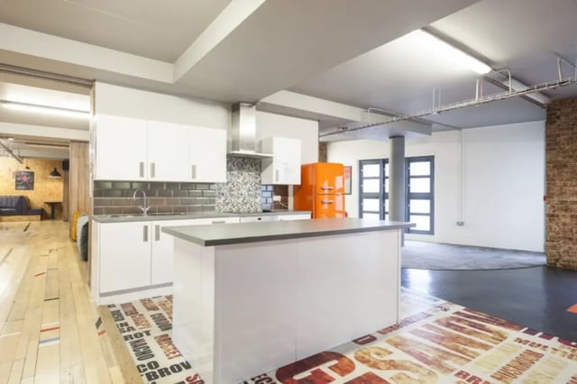 White cabinets orange fridge kitchen island kitchen at Mcmillan student Village in Greenwich Student Accommodation