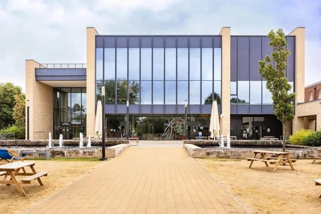 Modern building with fountains picnic tables and umbrellas exterior at Bonington Student Village in Loughborough Student Accommodation