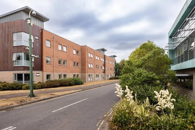 Brick building with windows and security cameras exterior at Bonington Student Village in Loughborough Student Accommodation