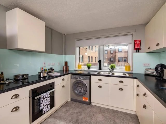 Corner kitchen with oven washing machine sink kitchen at Meadow Court in Edinburgh Student Accommodation