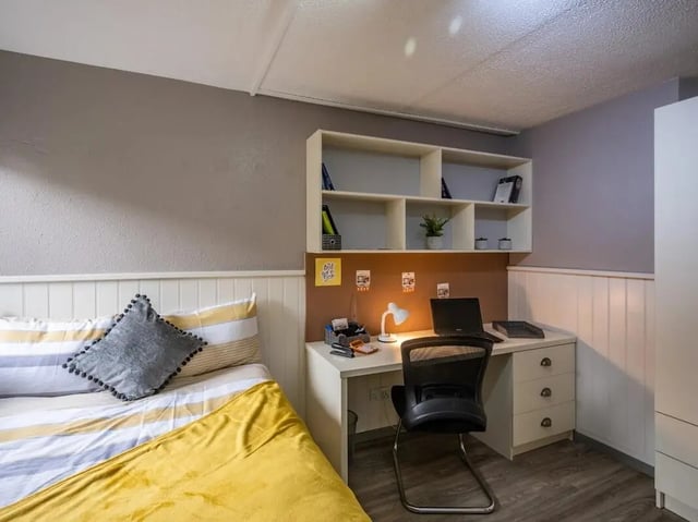 Bed desk shelves laptop chair lamp bedroom at Meadow Court in Edinburgh Student Accommodation